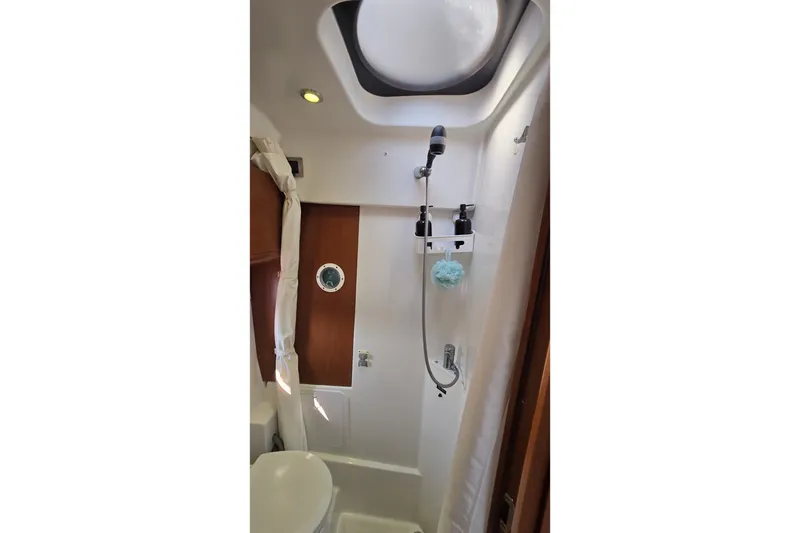 Slide: The Image of Bathroom interior of 2013 Beneteau Gran Turismo 38 yacht, featuring shower and porthole. - 34