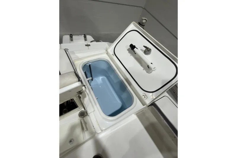 Slide: The Image of Open storage compartment on 2019 Crevalle 26 Bay boat, showcasing interior features. - 16