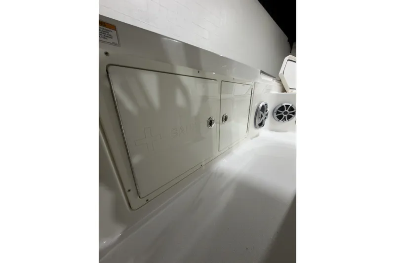 Slide: The Image of 2019 Crevalle 26 Bay boat interior with storage compartments and speakers. - 21