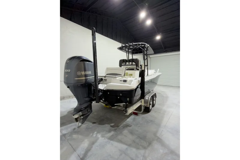 Slide: The Image of 2019 Crevalle 26 Bay boat with Yamaha 300 engine in a garage setting. - 8