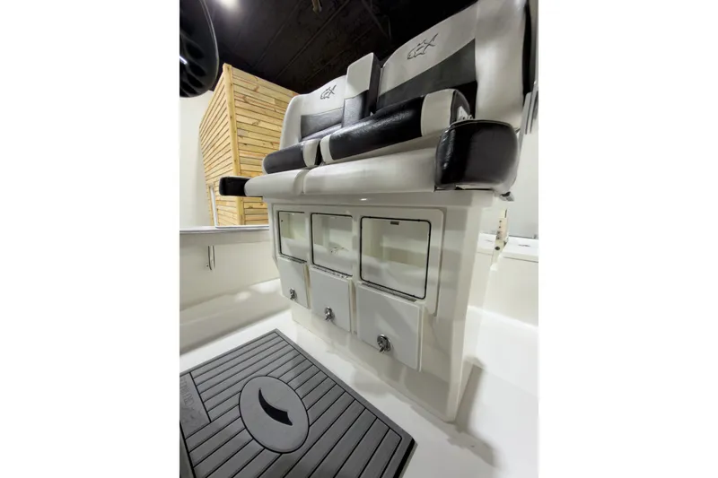 Slide: The Image of 2019 Crevalle 26 Bay boat interior with cushioned seating and storage compartments. - 25