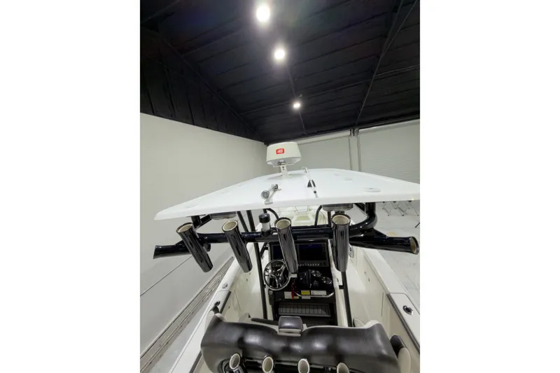 Slide: The Image of 2019 Crevalle 26 Bay boat interior with rod holders and console. - 24