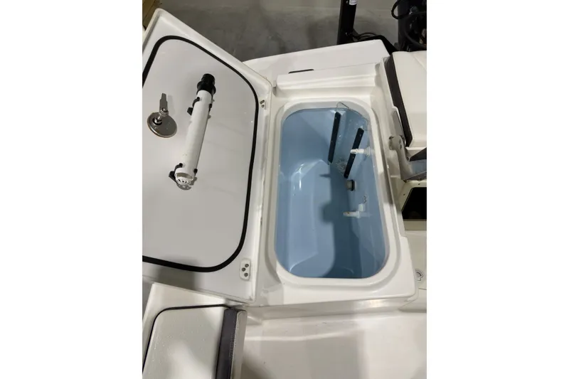 Slide: The Image of Open storage compartment on a 2019 Crevalle 26 Bay boat, showcasing interior features. - 14
