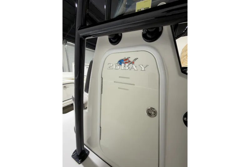 Slide: The Image of 2019 Crevalle 26 Bay boat console with logo and storage compartment. - 19