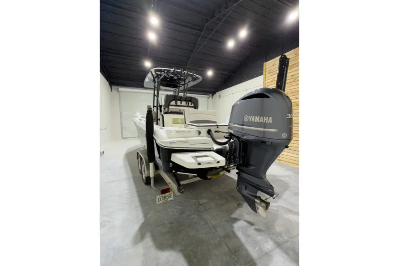 Slide: The Image of 2019 Crevalle 26 Bay boat with Yamaha engine in a garage setting. - 10
