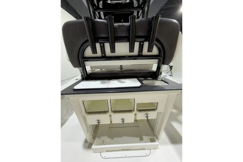 Slide: The Image of 2019 Crevalle 26 Bay boat interior with storage compartments and rod holders. - 26