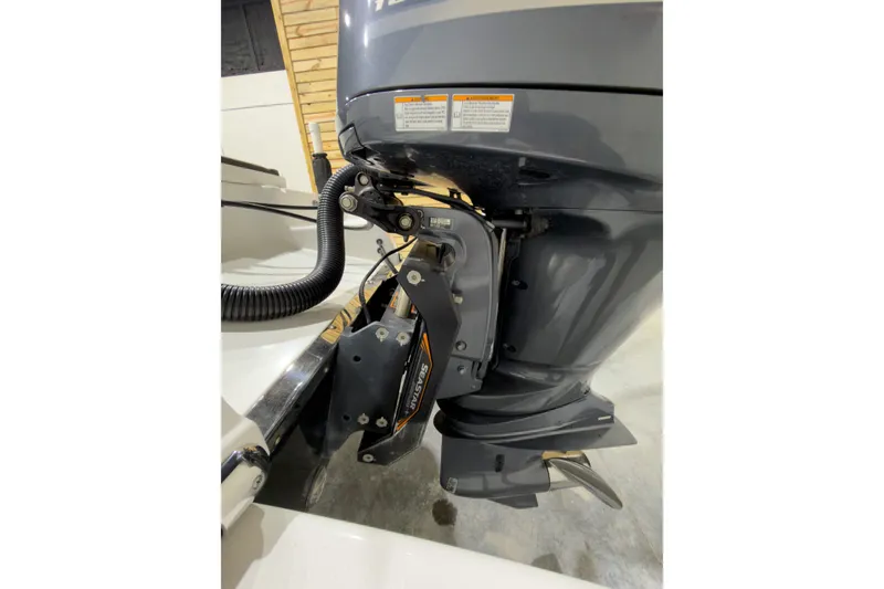 Slide: The Image of 2019 Crevalle 26 Bay boat engine close-up in a garage setting. - 27
