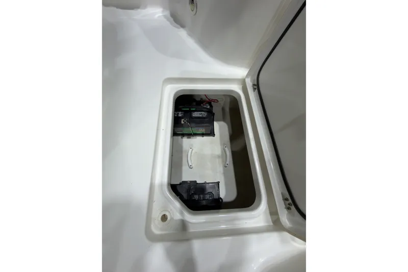 Slide: The Image of Battery compartment of 2019 Crevalle 26 Bay boat, featuring dual batteries. - 23