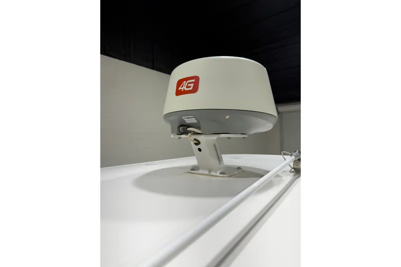 Slide: The Image of 4G antenna on 2019 Crevalle 26 Bay boat, mounted on white surface. - 4