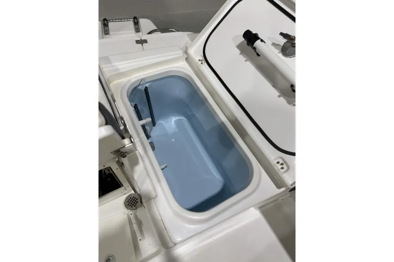 Slide: The Image of Open storage compartment on 2019 Crevalle 26 Bay boat, showcasing interior design. - 15