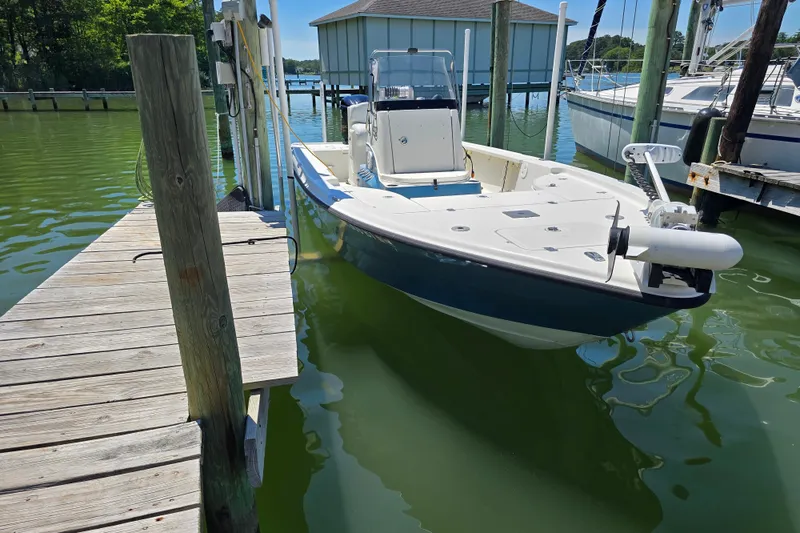 Slide: The Image of 2008 Triton 240 LTS Pro boat docked in a serene marina setting. - 9