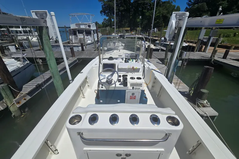 Slide: The Image of 2008 Triton 240 LTS Pro boat docked at marina, featuring center console and steering wheel. - 17