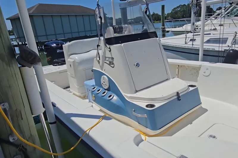 Slide: The Image of 2008 Triton 240 LTS Pro boat with center console, docked near other vessels. - 27