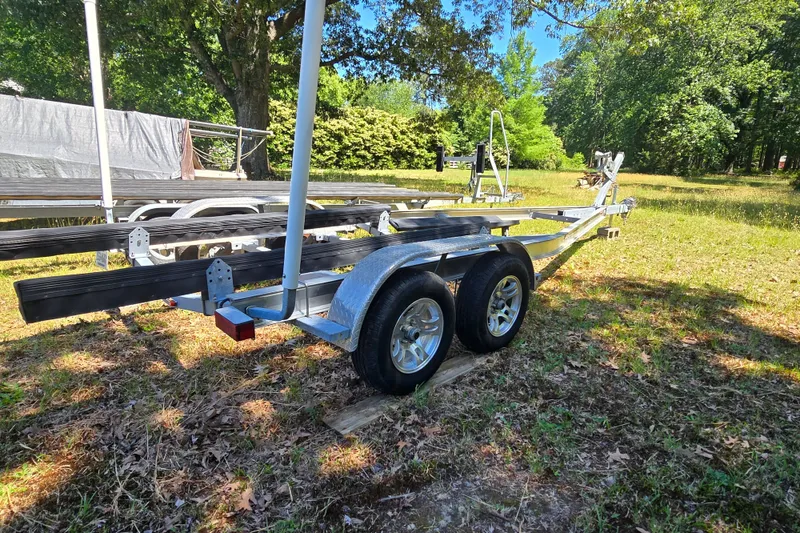 Slide: The Image of 2008 Triton 240 LTS Pro boat trailer in a grassy outdoor setting. - 10