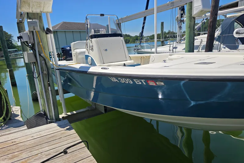 Slide: The Image of 2008 Triton 240 LTS Pro boat docked at marina, blue hull, registration VA 309 BT. - 8