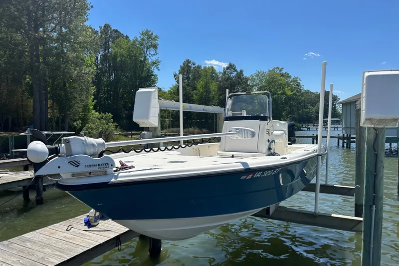 Slide: The Image of 2008 Triton 240 LTS Pro boat docked on a sunny day by the water. - 6