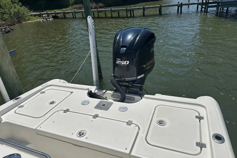 Slide: The Image of 2008 Triton 240 LTS Pro boat with Yamaha 250 engine, docked by the water. - 31