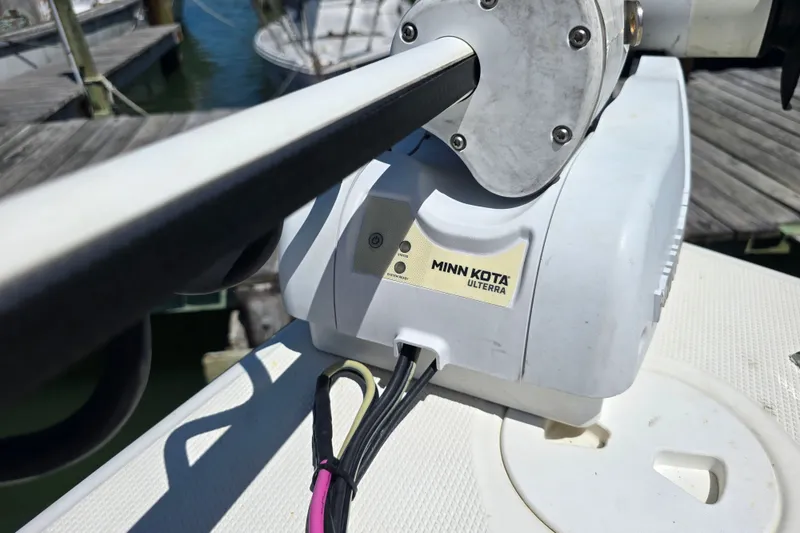 Slide: The Image of Minn Kota Ulterra motor on a 2008 Triton 240 LTS Pro boat at a dock. - 22