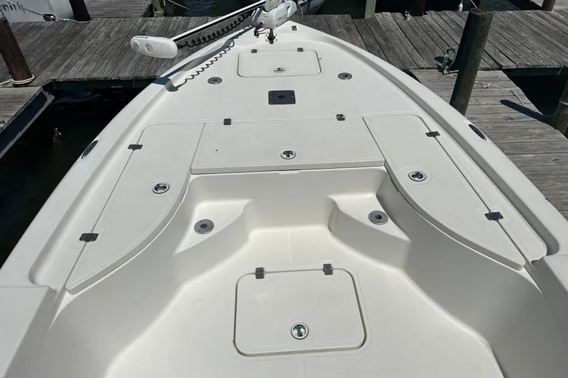 Slide: The Image of 2008 Triton 240 LTS Pro boat deck with storage compartments and trolling motor. - 23