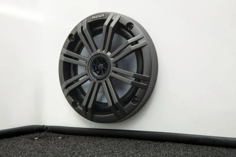Slide: The Image of A speaker is mounted in a white wall, surrounded by gray carpeting. - 26