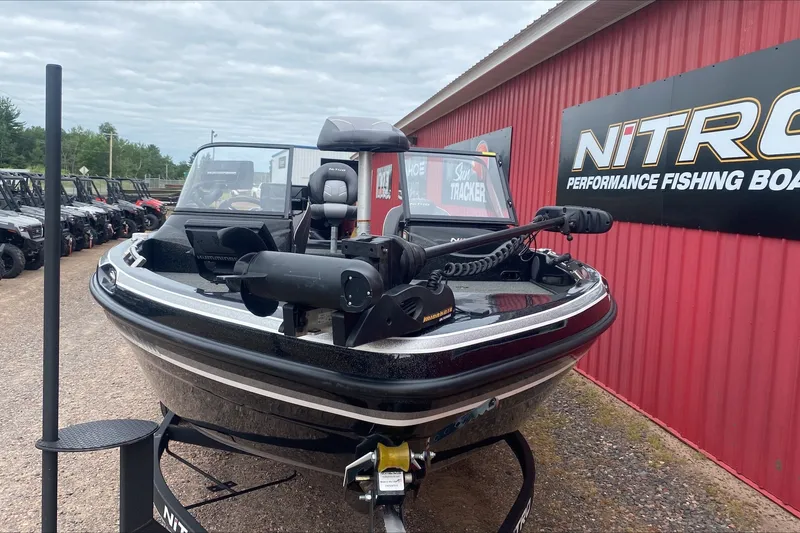 Slide: The Image of 2019 Nitro ZV19 Pro fishing boat displayed outside dealership with red siding. - 5