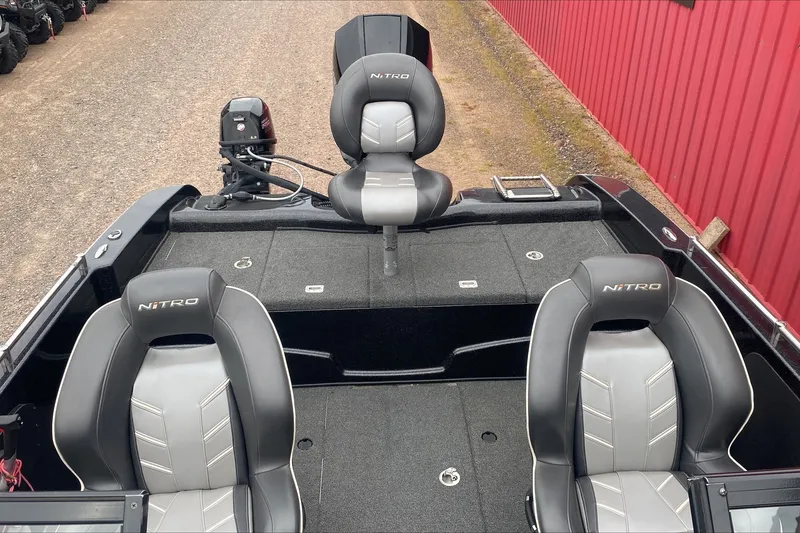Slide: The Image of 2019 Nitro ZV19 Pro boat interior with three cushioned seats and fishing equipment. - 8