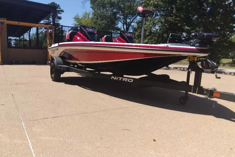 Slide: The Image of 2027 Nitro Z18 XL Pro boat on trailer, red and white design, parked outdoors. - 5