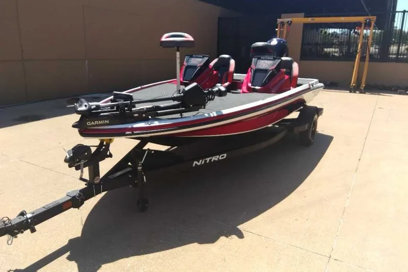 The Image of 2027 Nitro Z18 XL Pro fishing boat with Garmin equipment, parked outdoors. - 0