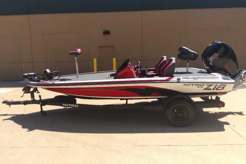 Slide: The Image of 2027 Nitro Z18 XL Pro fishing boat with red and black design on a trailer. - 1