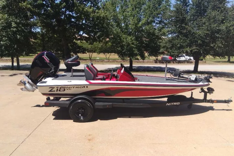 Slide: The Image of 2027 Nitro Z18 XL Pro boat on trailer, parked outdoors, side view. - 2