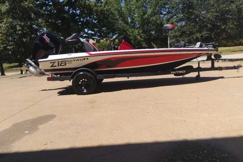 Slide: The Image of 2027 Nitro Z18 XL Pro boat on trailer, parked outdoors in sunny setting. - 6
