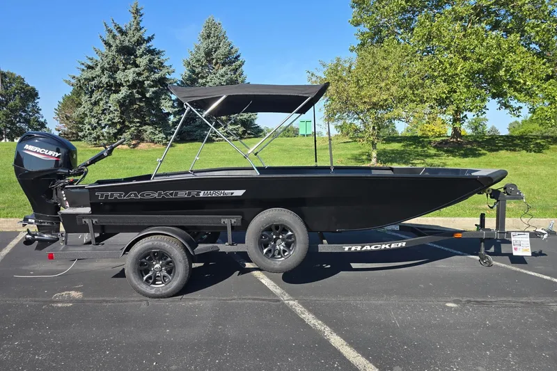 The Image of 2027 Tracker Grizzly 1756 T Marsh boat on trailer, parked outdoors. - 0