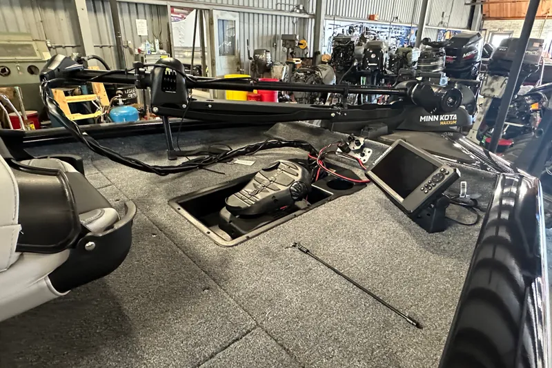 Slide: The Image of 2027 Tracker Pro Team 175 boat interior with Minn Kota trolling motor and control panel. - 60