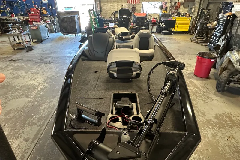 Slide: The Image of 2027 Tracker Pro Team 175 boat in a workshop, featuring seating and equipment. - 59