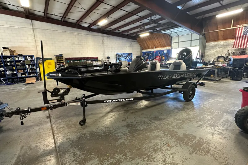 Slide: The Image of 2027 Tracker Pro Team 175 boat in a workshop, mounted on a trailer. - 57