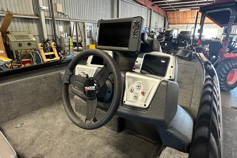 Slide: The Image of Interior of 2027 Tracker Pro Team 175 boat with steering wheel and control panel. - 55