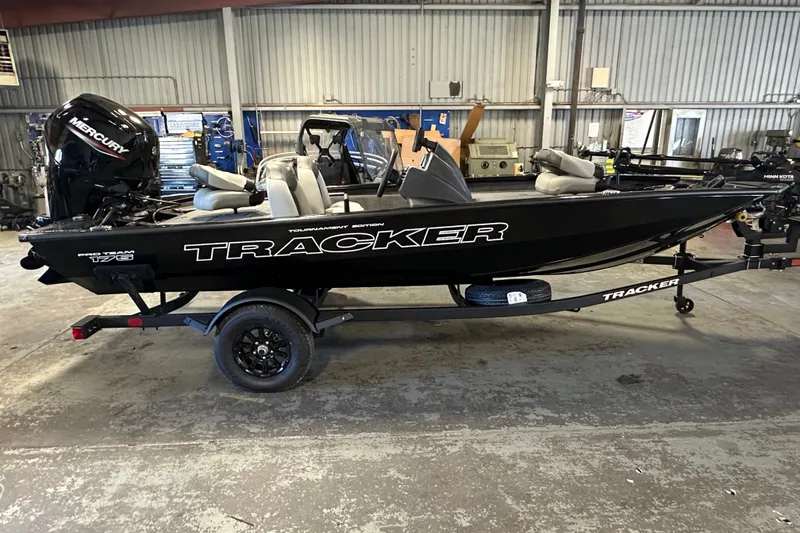 Slide: The Image of 2027 Tracker Pro Team 175 boat in a garage, featuring a Mercury engine. - 50