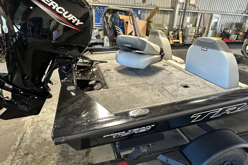 Slide: The Image of 2027 Tracker Pro Team 175 boat with Mercury engine in a workshop setting. - 53