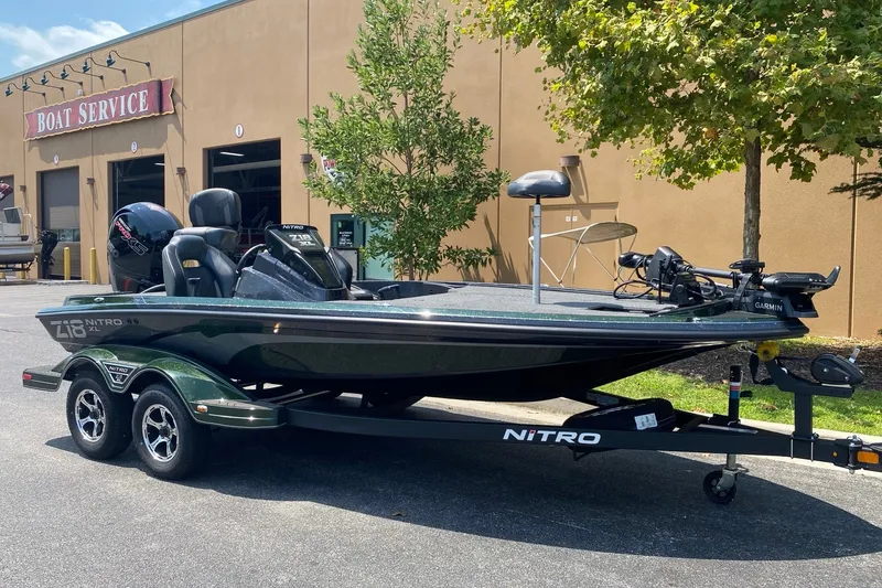 Slide: The Image of 2027 Nitro Z18 XL Pro boat on trailer outside service center. - 2