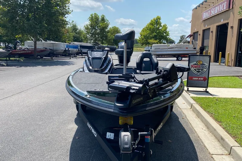 Slide: The Image of 2027 Nitro Z18 XL Pro boat parked near service center, sunny day. - 6