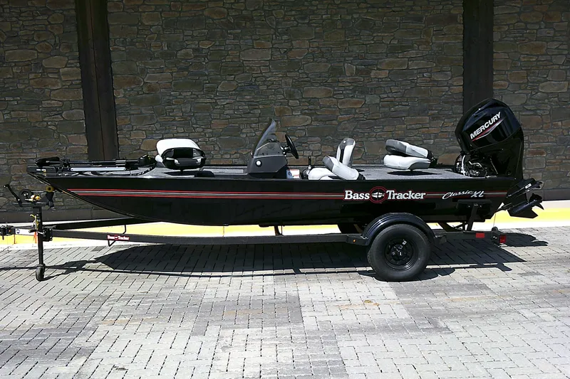 The Image of 2027 Tracker Bass Tracker Classic XL boat on trailer, parked on brick pavement. - 0
