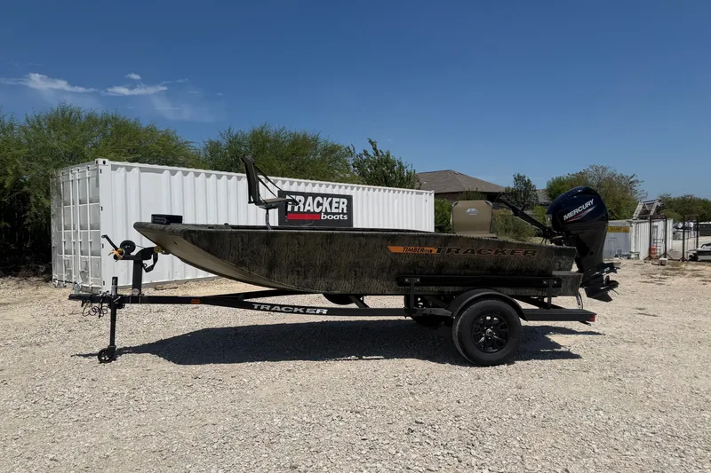 The Image of 2027 Tracker Grizzly 1553 Timber boat on trailer, parked outdoors under clear sky. - 0
