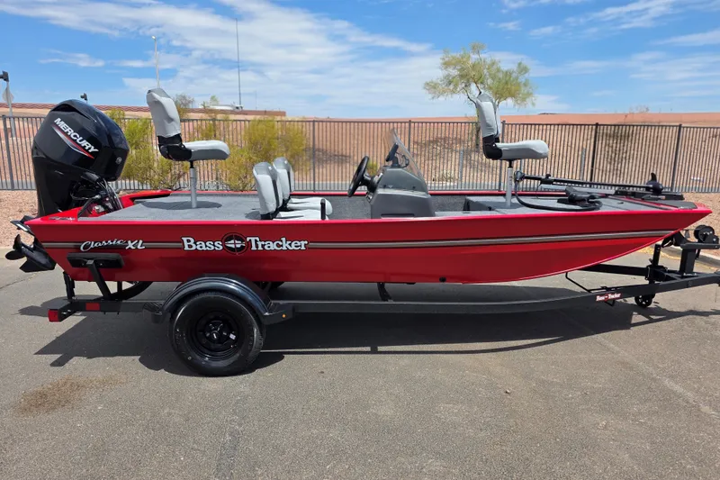 The Image of 2027 Tracker Bass Tracker Classic XL boat, red with Mercury engine, parked outdoors. - 0