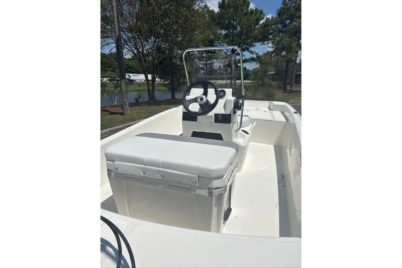 Slide: The Image of 2026 Mako Pro Skiff 15 CC boat interior with steering console and seating. - 3