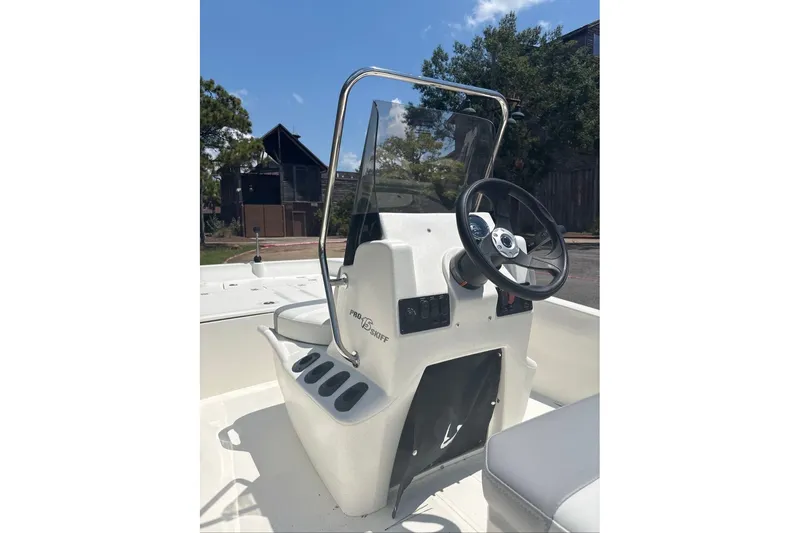 Slide: The Image of 2026 Mako Pro Skiff 15 CC boat console with steering wheel and controls. - 5