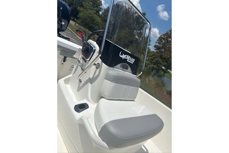 Slide: The Image of 2026 Mako Pro Skiff 15 CC boat console with seating and steering wheel. - 9