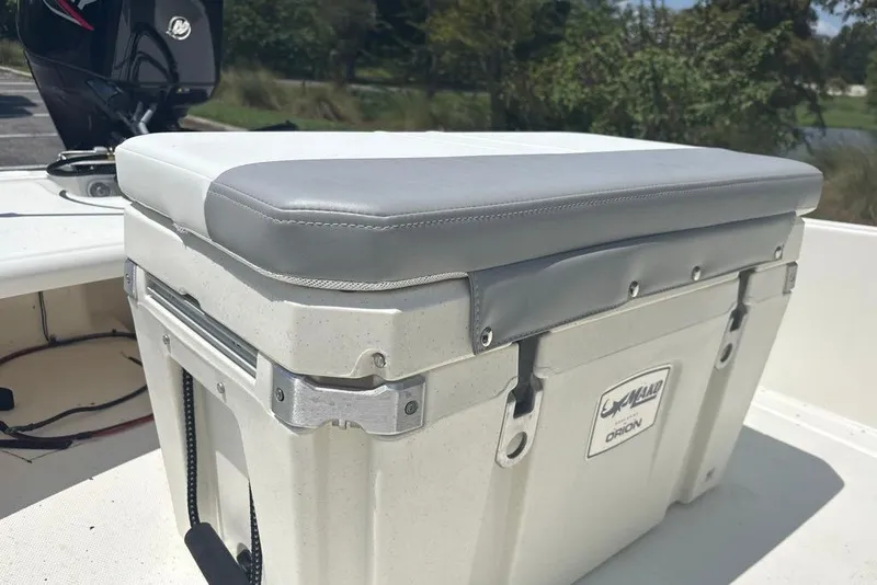 Slide: The Image of Cushioned cooler seat on 2026 Mako Pro Skiff 15 CC boat deck. - 11