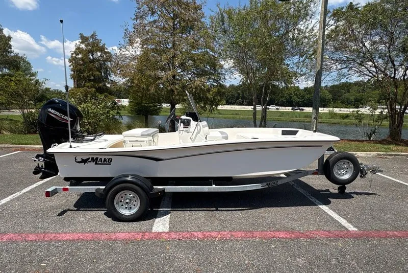 Slide: The Image of 2026 Mako Pro Skiff 15 CC boat on trailer in parking lot, sunny day. - 7