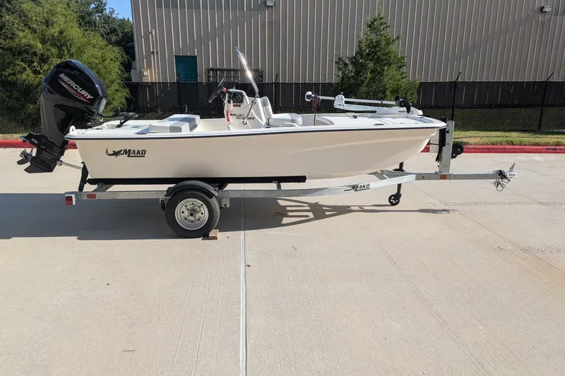 Slide: The Image of 2026 Mako Pro Skiff 13 CC boat on trailer, parked outdoors. - 1