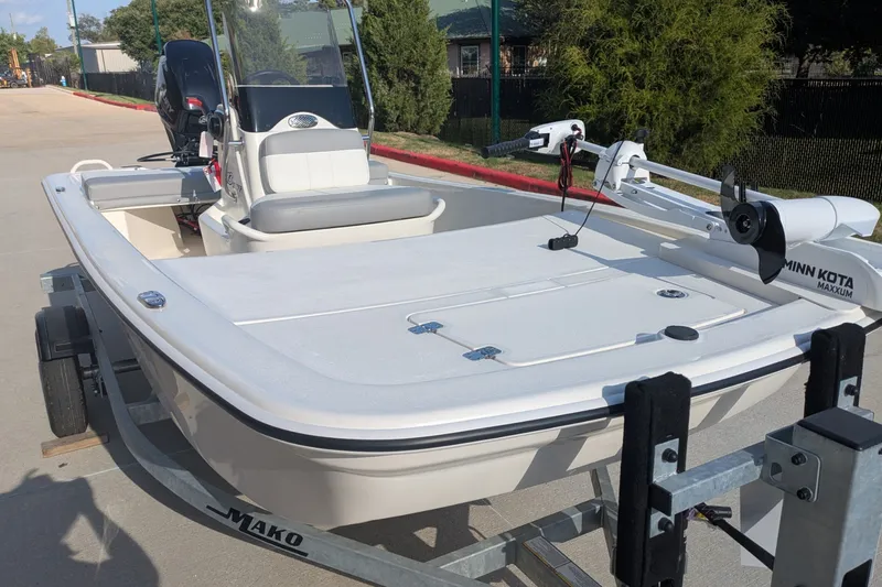 Slide: The Image of 2026 Mako Pro Skiff 13 CC boat on trailer, featuring Minn Kota Maxxum trolling motor. - 2